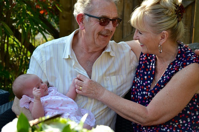 Happy grandparents with new born baby