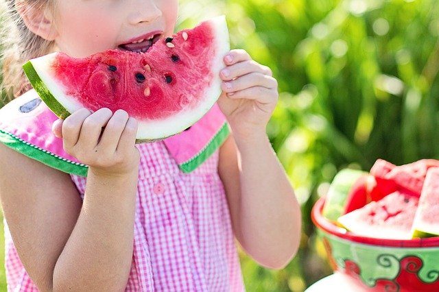 Little child eating watermelon